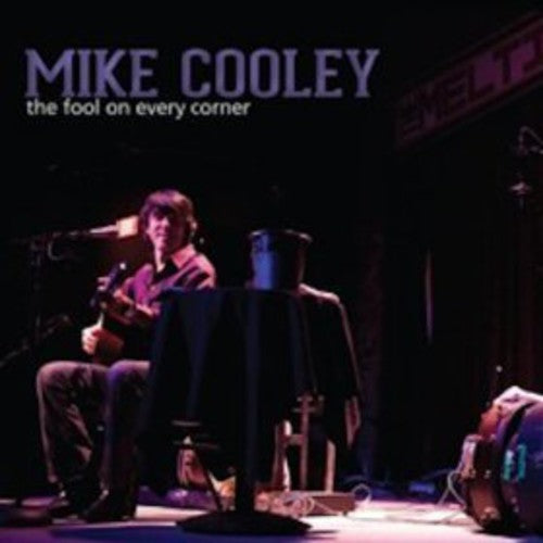 the album cover for Mike Cooley - The Fool On Every Corner