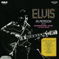 the album cover for Elvis Presley - In Person At The International Hotel Las Vegas Nevada [Audiophile Translucent Gold & Blue Swirl LP]