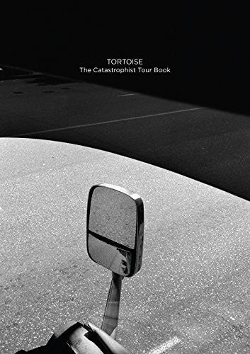 the album cover for Tortoise - Catastrophist Cd & Tour Book (W/Book)