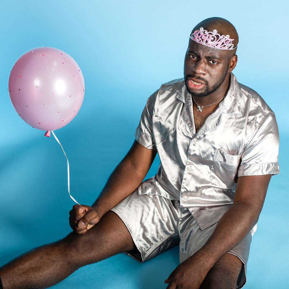 the album cover for Nnamdi - Brat [Indie Exclusive Limited Edition Clear with Pink & Blue Splatter LP]