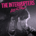 the album cover for The Interrupters - Live In Tokyo! [Indie Exclusive Limited Edition Pink & Black Pinwheel LP]
