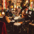 the album cover for Ezra Collective - Where I'm Meant To Be [Deluxe Orange & Yellow Marbled 2LP]