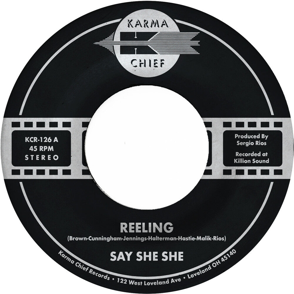 the album cover for Say She She - Reeling / Don't You Dare Stop - Metallic Green