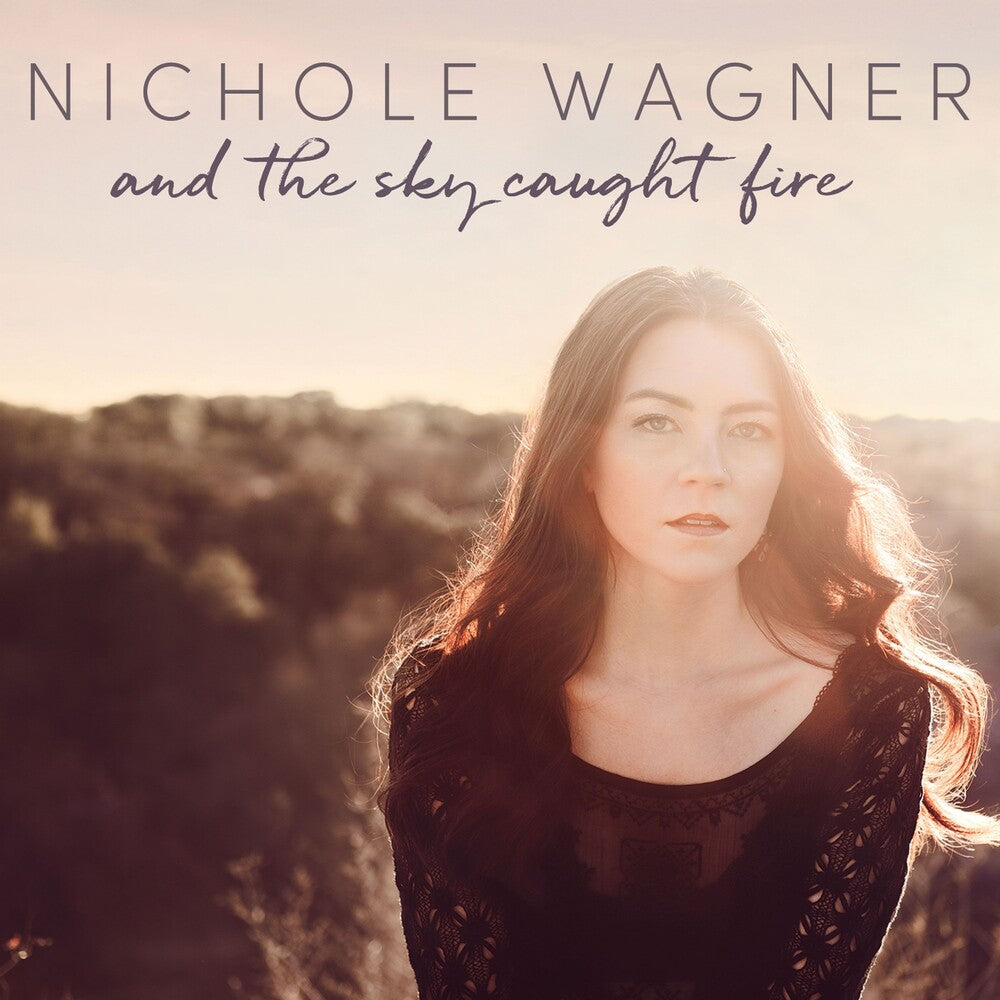 the album cover for Nichole Wagner - And The Sky Caught Fire