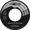 the album cover for Say She She - I Believe In Miracles / C'est Si Bon [Colored Vinyl]
